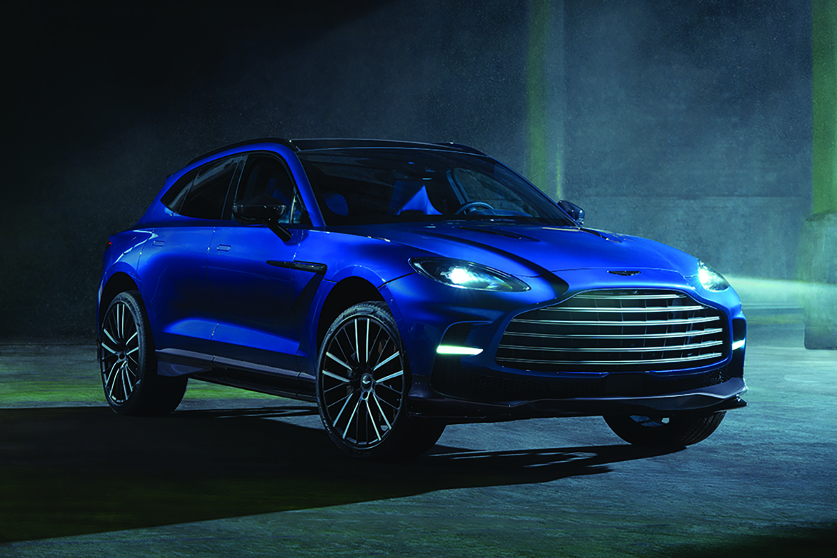 Blue Aston Martin DBX707 in dark background